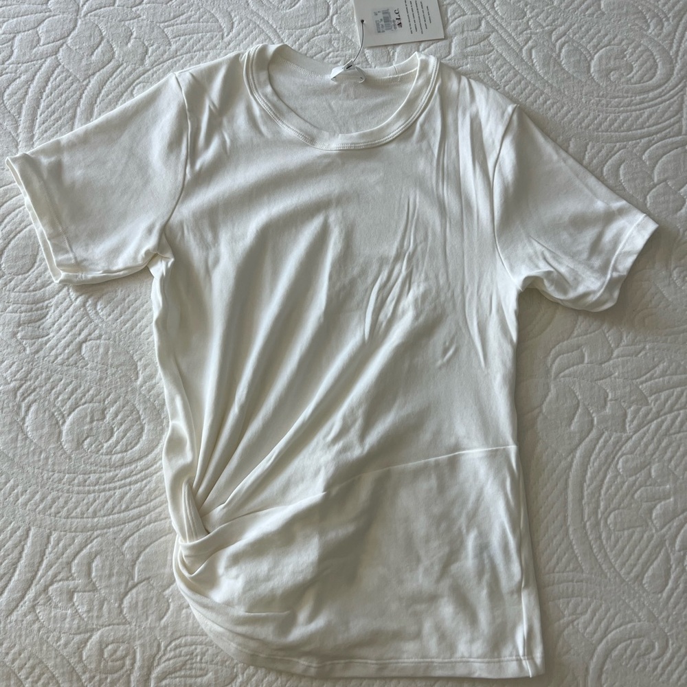 A.L.C. White t-shirt with a knot on the side. Brand new with tag. Never worn.